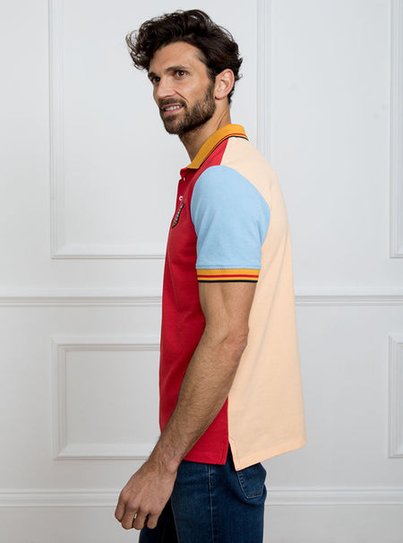 Man wearing multicoloured polo shirt with giant number 5 on the back, made of 100% cotton.